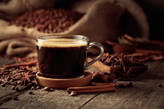 Cup of black coffee on an old wooden table.