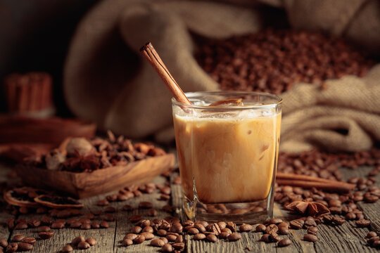 Iced coffee with cream on an old wooden table.