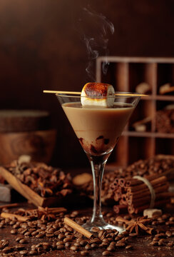 Cream and coffee cocktail, decorated with toasted marshmallow.