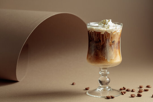 Cream and coffee cocktail on beige background.