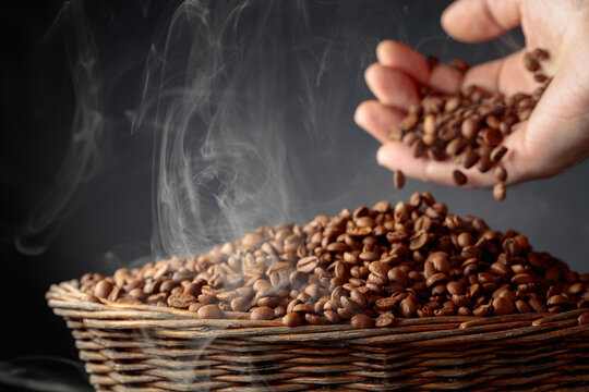The freshly roasted coffee beans are poured into a basket.