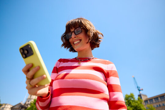 Attractive woman checking her phone in town