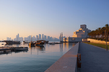 Fototapeta premium Museum of Islamic Art with Doha Skyline and Traditional Dhow Boats, Qatar