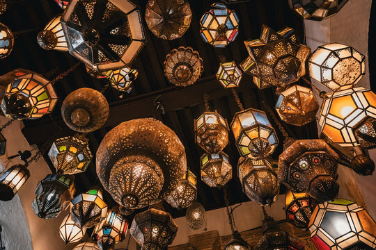 Various traditional moroccan lamps on the ceiling at the entrance of moroccan riyad house in Rabat