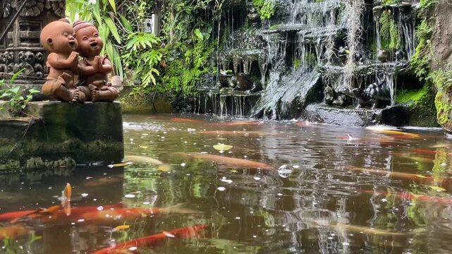 Beautiful Koi Pond with Tropical Waterfall and Laughing Monk Statues