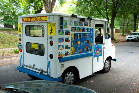 Mobile kids ice cream truck on wheels going through the neighborhood hoping for customers by ringing a bell. St Paul Minnesota MN USA