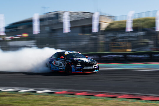 Drift car action, drifting on racetrack with large amount of smoke, blurred motion background