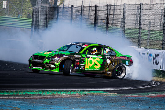 Drift car action, drifting on racetrack with large amount of smoke