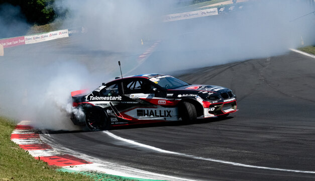 Drift car action, drifting on racetrack with large amount of smoke