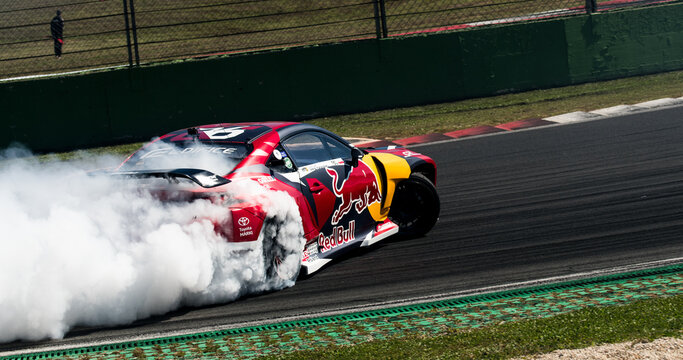 Drift car action, drifting on racetrack with large amount of smoke