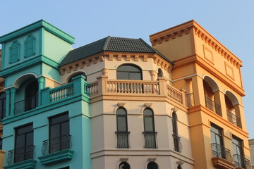 Obraz premium Exterior view of mediterranean buildings with pastel colors and classic balconies.