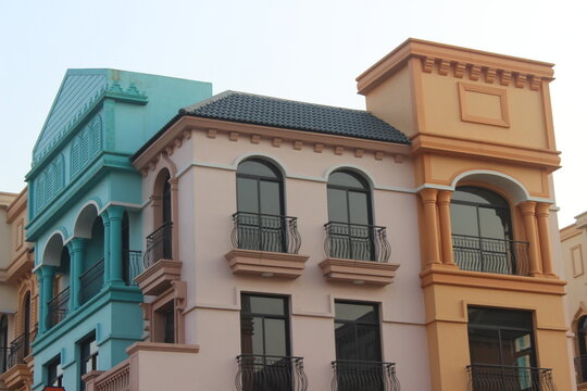 Close up shot of European style colonial architecture with pastel colored facades.