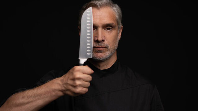 Portrait of positive 50s mature chef cook, black outfit