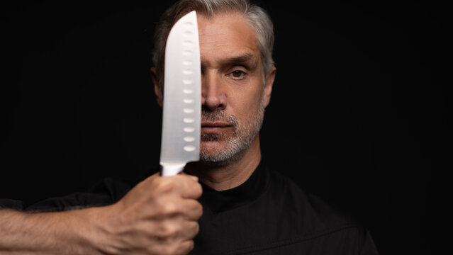 Portrait of positive 50s mature chef cook, black outfit