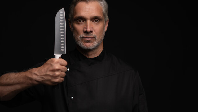 Portrait of positive 50s mature chef cook, black outfit