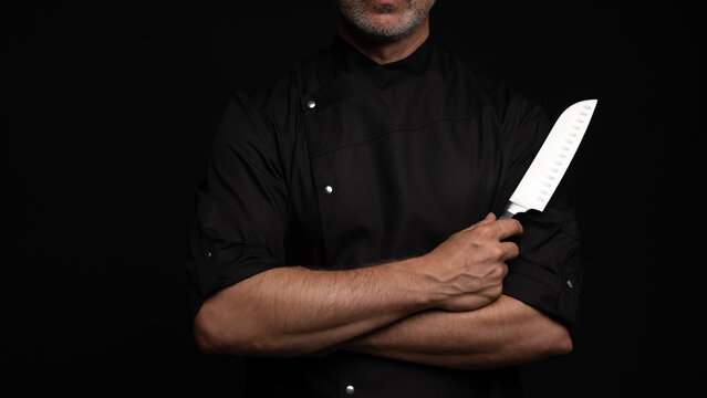 Portrait of positive 50s mature chef cook, black outfit