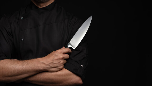 Portrait of positive 50s mature chef cook, black outfit