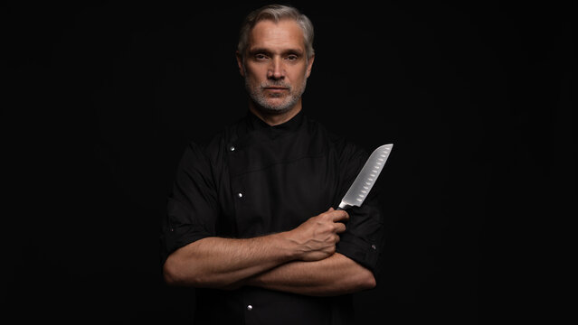 Portrait of positive 50s mature chef cook, black outfit