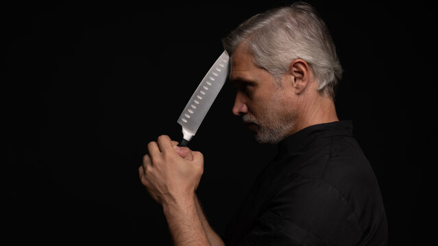 Portrait of positive 50s mature chef cook, black outfit