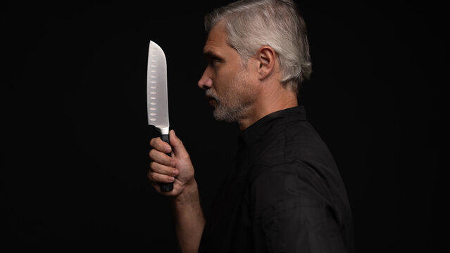 Portrait of positive 50s mature chef cook, black outfit
