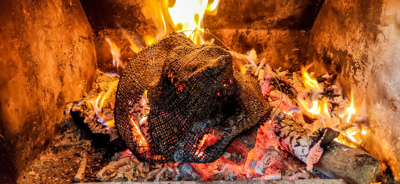 Fireplace burning wood and mesh sack in arnedo