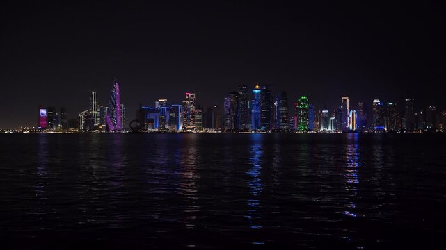 Doha West Bay Skyline at Night with Vibrant Light Reflections on Corniche Waters &ndash; Qatar