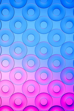 3D blue donut gradient pattern shifts into luminous magenta.