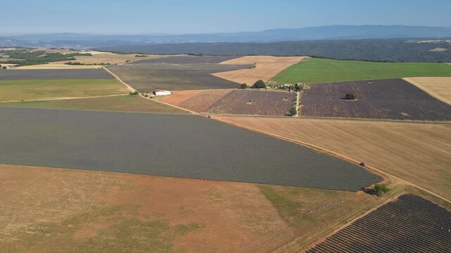 Aerial panorama of patchwork farmland and lavender fields across the Plateau de Valensole, Provence, France
