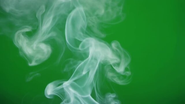 Wisps of white vapor gracefully ascend against a vibrant green background with subtle cinematic motion for visual effects