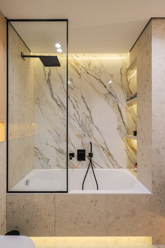 Modern bathtub with glass shower screen
