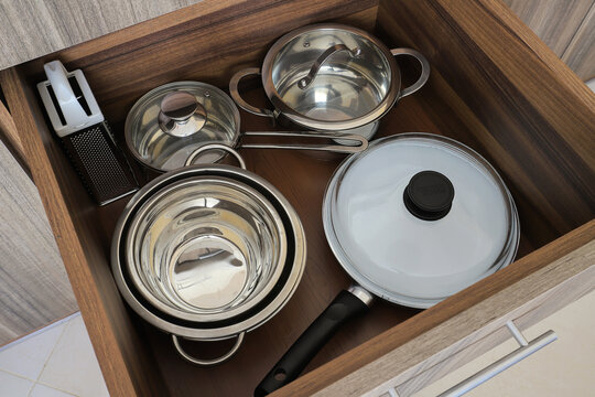 Kitchen drawer filled with metal cookware