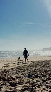 Woman playing with happy corgi on Baleal beach Portugal

Young woman enjoying playful moments with her corgi mix on Baleal Beach in Portugal surrounded by dramatic Atlantic coastline, cliffs and light