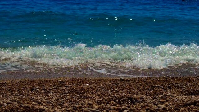 Turquoise Sea Wave Crashing On Pebble Beach. Seashore. Summer Vacation 