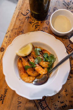 High angle view of plate of fresh-caught shrimp prepared with lemon and parsley in Lisbon, Portugal 