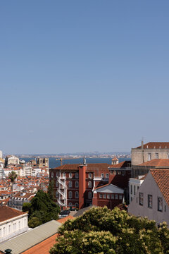 view of Lisbon city with architecture with Tagus River in the background, blue sky, sunny day