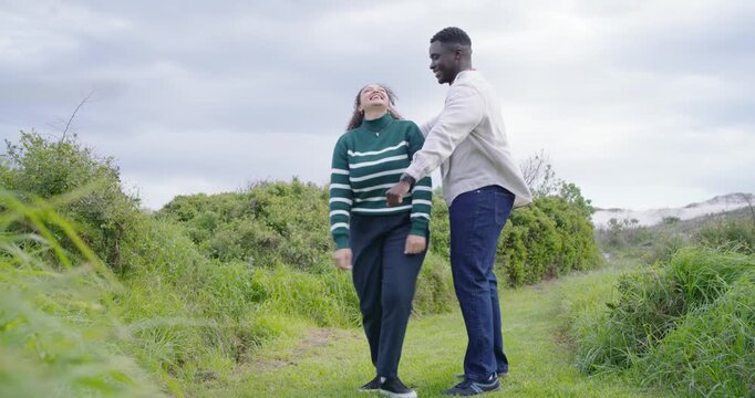 African American couple dancing on dune path woman starting playful dance man guiding showing love