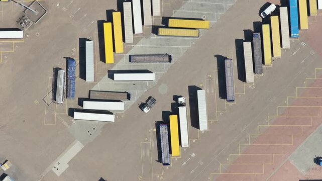 Aerial View of Shipping Containers and Trucks in a Large Storage Yard