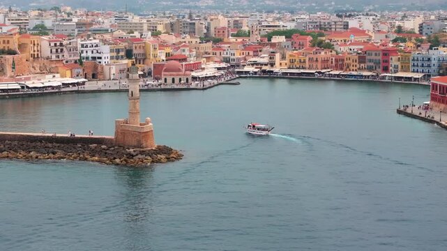  View of Chania with the amazing lighthouse, mosque, venetian shipyards, Crete, Greece.Waves crashing on lighthouse, Beautiful Greece and best scenic places - panorama