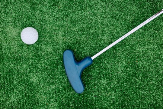 Mini Golf Putter and Ball on Artificial Green Putting Course
