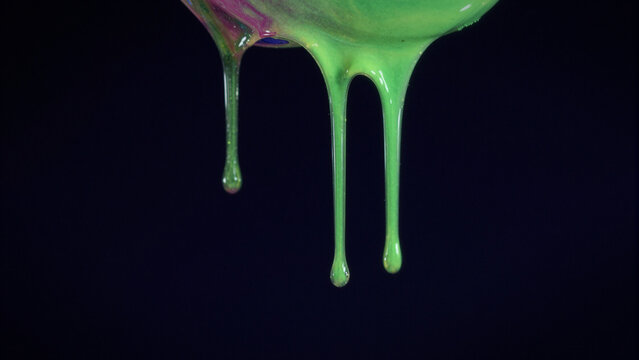 green slime dripping down against a dark black background