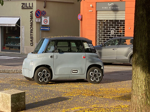 Citroen Ami electric quadricycle parked on Piazza Guglielmo Marconi street, Cremona, Italy, enjoying sunny day