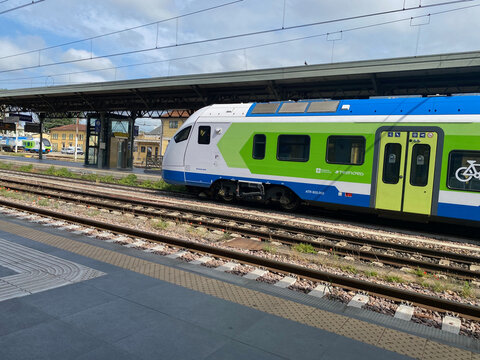 Passenger train ATR 803.013 stopping at a station platform, showcasing modern public transport and travel