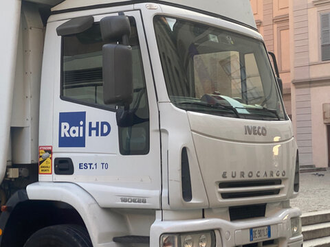 IVECO Eurocargo truck displaying the RAI HD logo, symbolizing media, communication, and transportation in an Italian city