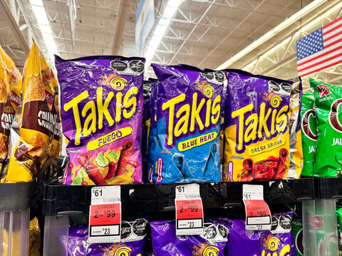 Bags of Takis Fuego, Blue Heat and Salsa Brava chips by Barcel, Grupo Bimbo displayed on a supermarket shelf. Spicy savory snacks on retail store racks. Guadalajara, Mexico July, 11, 2026. flaming hot