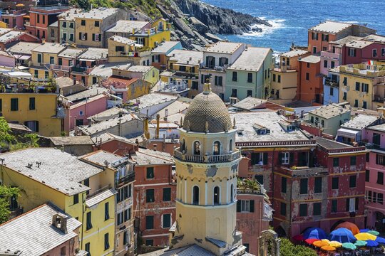 The village of Vernazza with its nested pastel-coloured houses built into the hillside, view from the Via dellAmore hiking trail, Vernazza, Cinque Terre, Ligurian Coast, Liguria, Italy