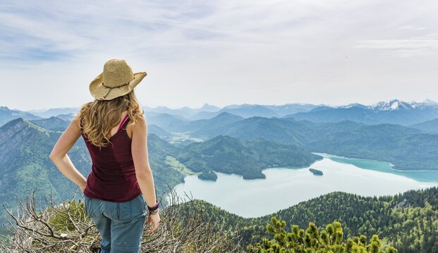Hiker looking towards Lake Kochel, Herzogstand Heimgarten ridge walk, Upper Bavaria, Bavaria, Germany
