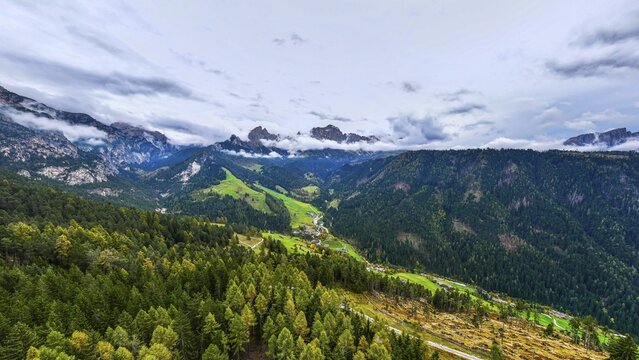 The peaks of the rose garden, shrouded in mist, drone shot, Dolomites, Autonomous Province of Bolzano, South Tyrol, Italy