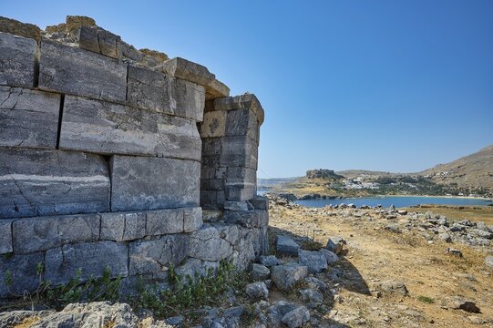 Ruin of an old stone tower with a view of the rocky coast and the blue water in the distance, tomb of Cleovoulos the Lindian, ruin, near Lindos, Lindos, Rhodes, Dodecanese, Greek Islands, Greece