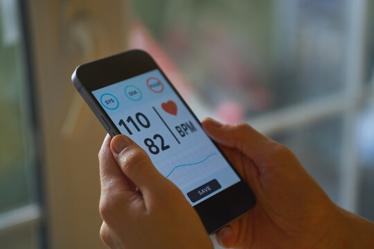 Mobile app showing blood pressure and heart rate on phone
