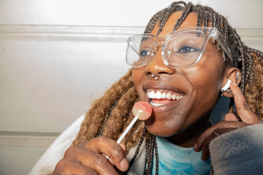 Gen Z woman enjoying urban lifestyle with lollipop